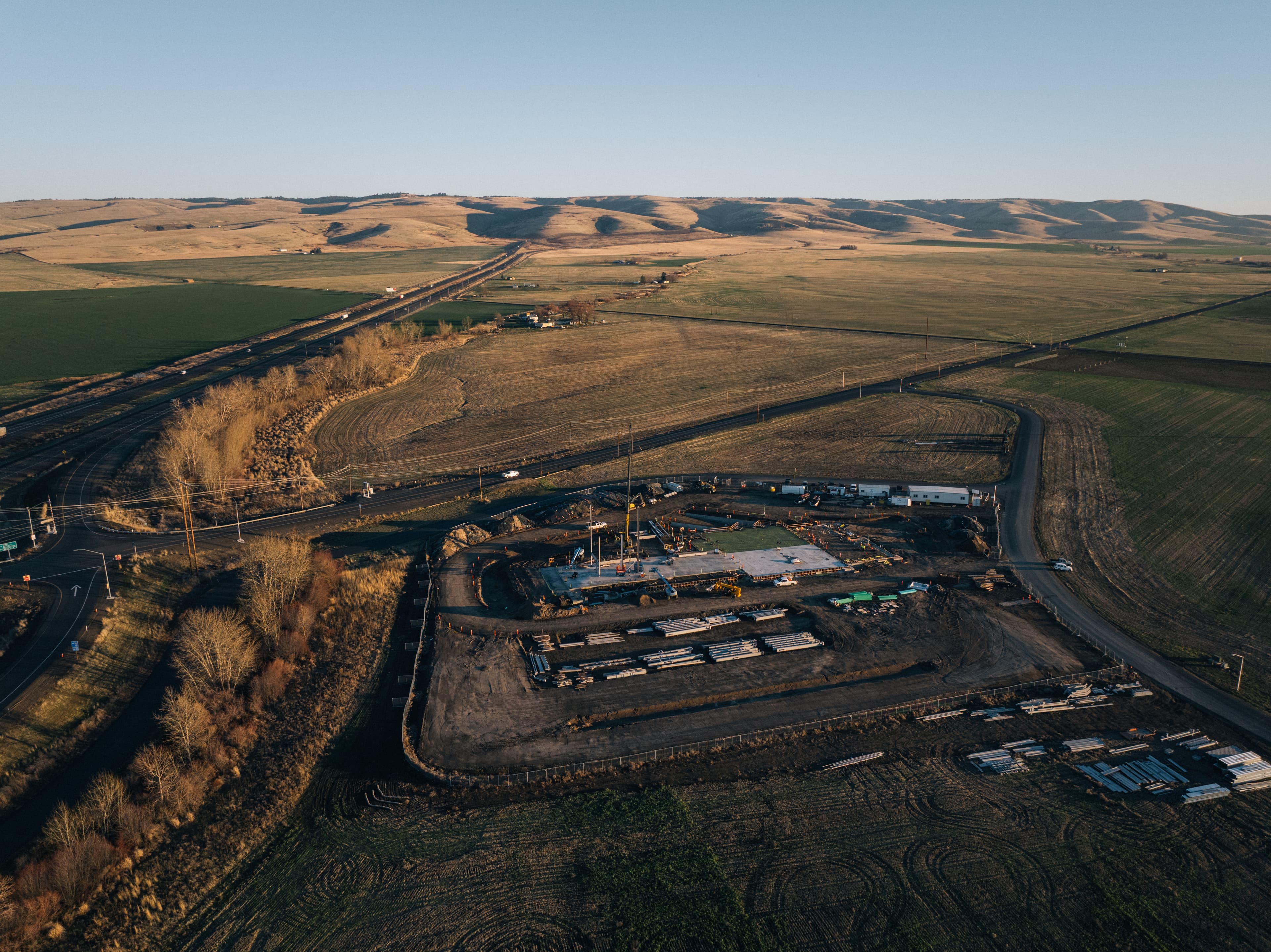 Aerial view of the Cairnspring Mills Blue Mountain Mill construction site in Pendleton, Oregon, with active steel structure erection underway.